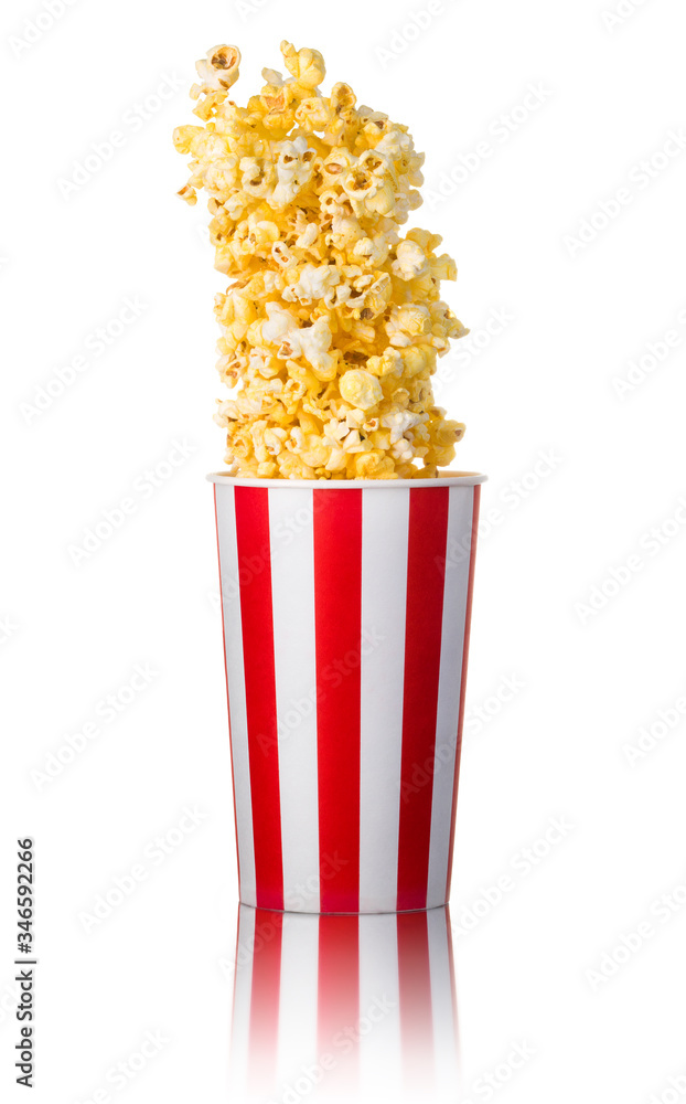Flying popcorn from paper striped bucket isolated on white background Flying popcorn from paper striped bucket isolated on white background