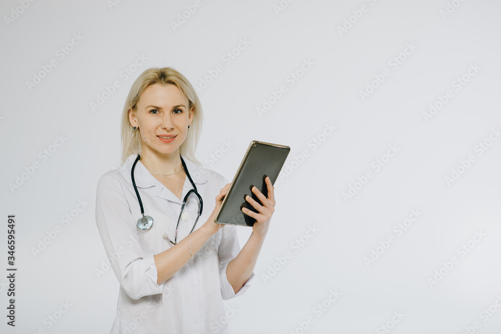 Female doctor writing the patient's condition on progress note in a file. Doctor using a digital tablet. Female doctor writing the patient's condition on progress note in a file. Doctor using a digital tablet.