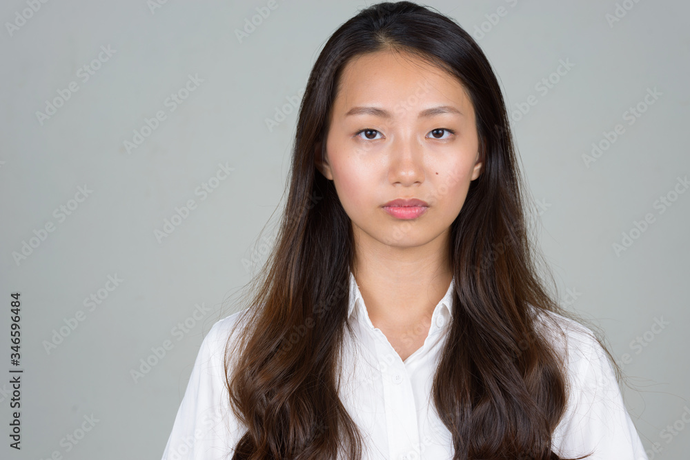 Face of young beautiful Asian businesswoman looking at camera Face of young beautiful Asian businesswoman looking at camera
