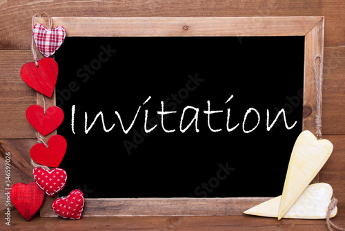 Balckboard With English Text Invitation. Red And Yellow Heart Decoration. Brown Wooden Background