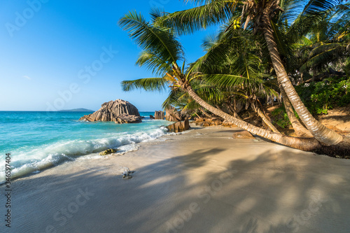 Anse Patates at La Digue, Seychelles. Small and beautiful beach, surrounded by granite boulders and coconut palms. Shot at sunset.