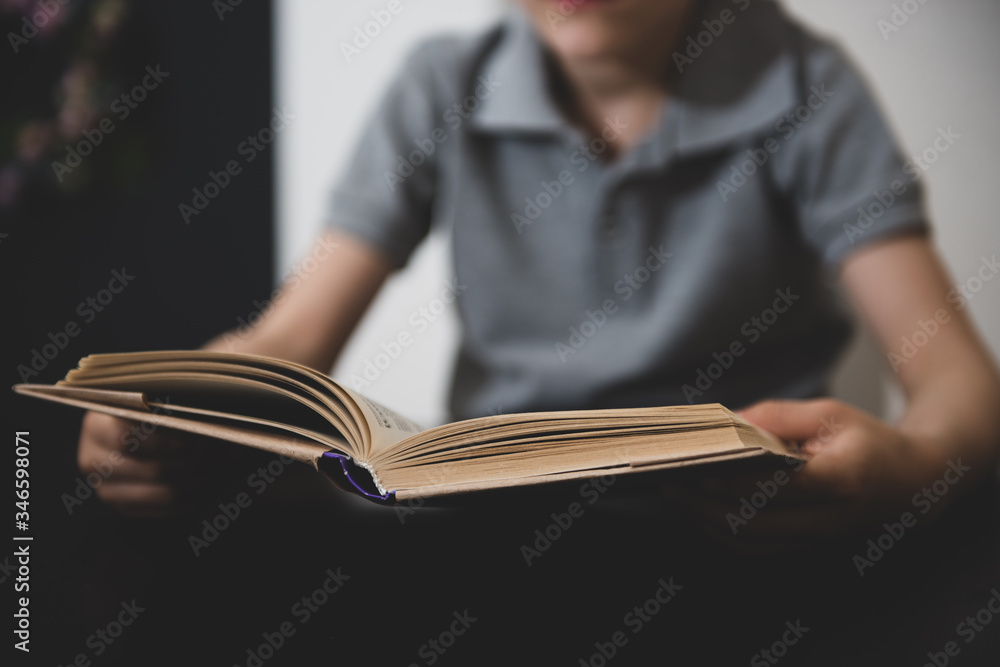 vague image of a boy reading a book vague image of a boy reading a book