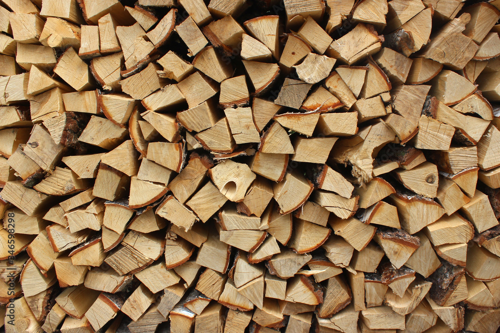 A heap of chopped firewood in woodpile A heap of chopped firewood in woodpile