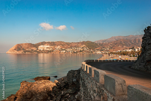 Coastal road leading in to the beach resort of La Herradura, Costa Tropical, Andalusia, Spain overlooking the calm bay water on a sunny summer morning