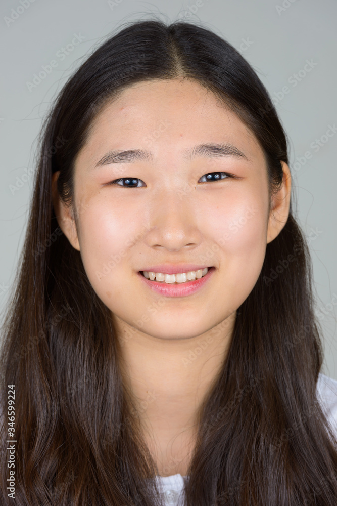 Face of happy young beautiful Asian woman smiling Face of happy young beautiful Asian woman smiling