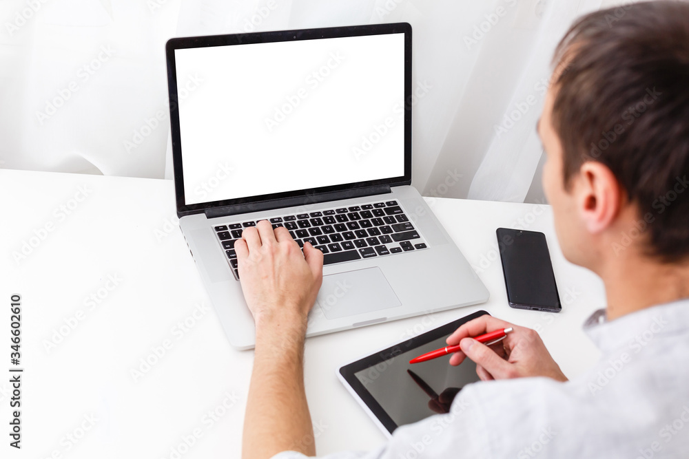 Back view of male person sitting front open laptop computer with blank empty screen for your information or content, modern businessman working in internet Back view of male person sitting front open laptop computer with blank empty screen for your information or content, modern businessman working in internet