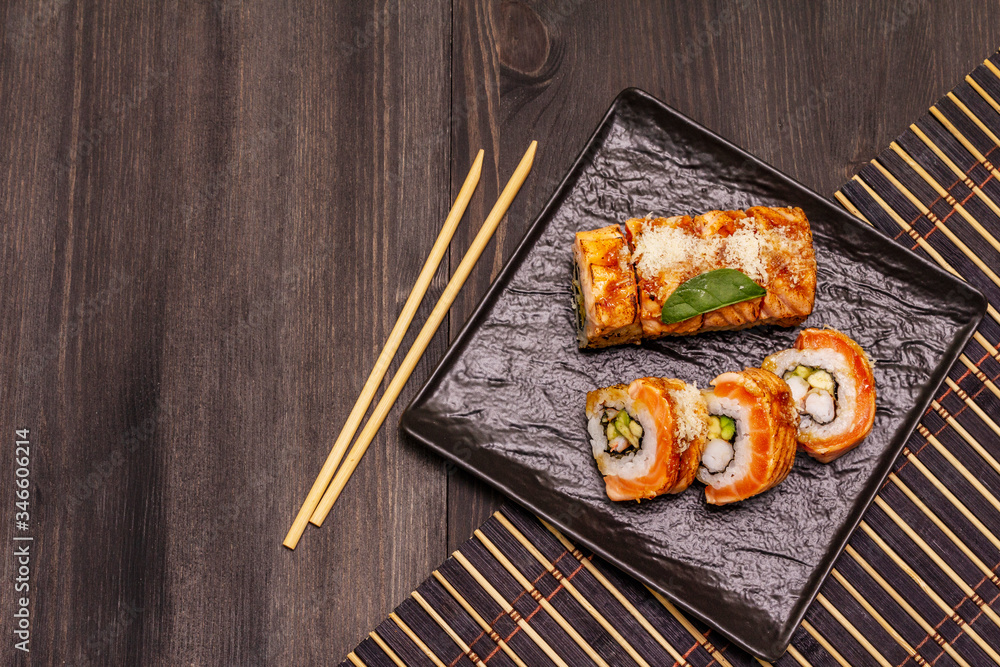 Grilled tiger prawn sushi. Japanese or Korean roll with different fresh ingredients. Trendy black background Grilled tiger prawn sushi. Japanese or Korean roll with different fresh ingredients. Trendy black background