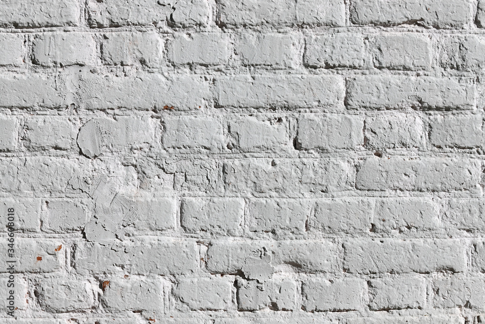 Fototapeta premium Texture of an old brick wall painted in white
