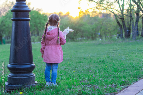 little girl outdoors alone with a toy  without parents  social