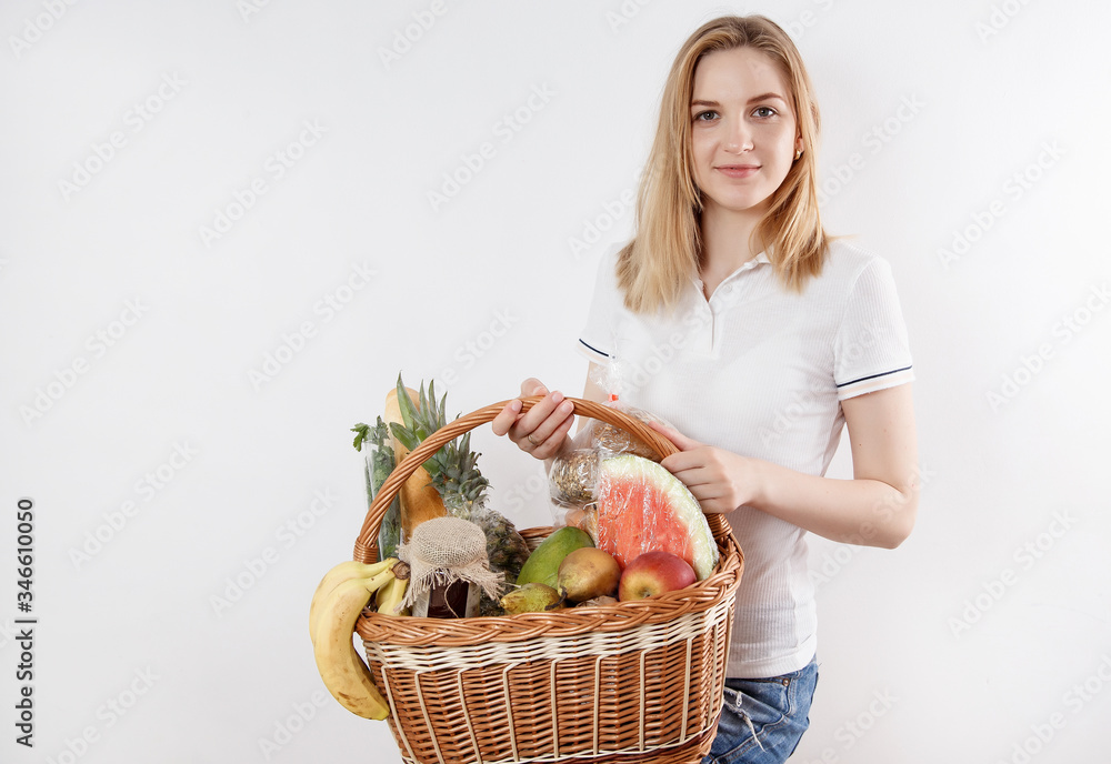 Girl with a whole shopping cart. Young woman with groceries in a wicker basket. Lady with groceries. Girl with a whole shopping cart. Young woman with groceries in a wicker basket. Lady with groceries.