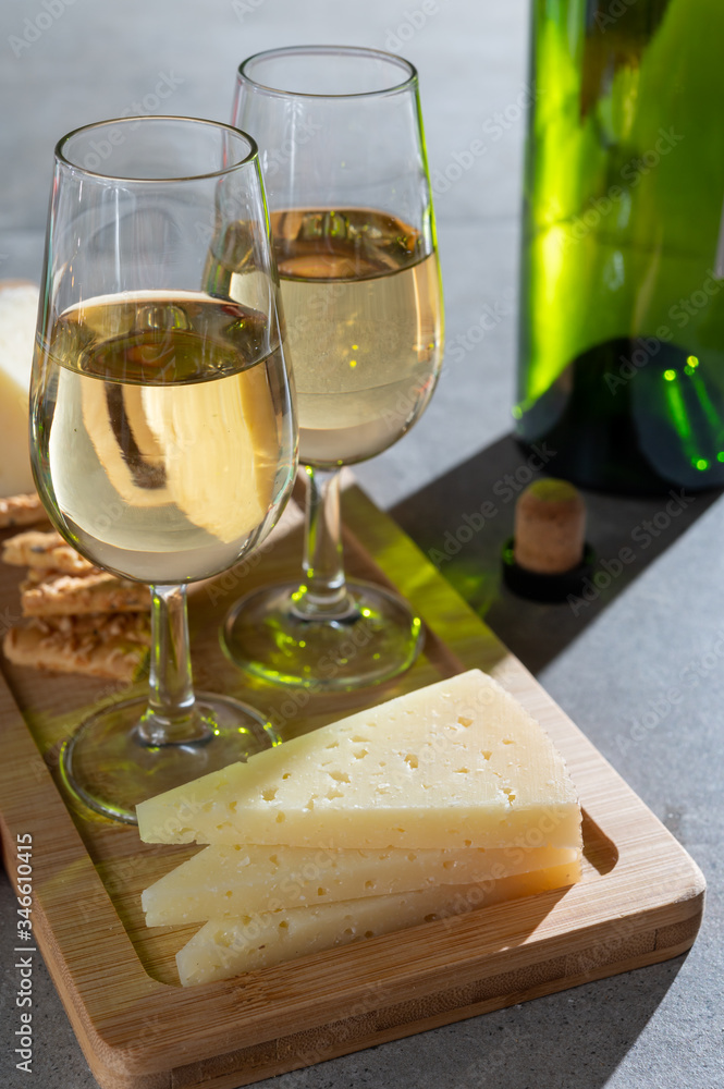 Glasses of dry fino sherry wine served with spanish tapas, manchego cheese, green olives, cheese crackers Glasses of dry fino sherry wine served with spanish tapas, manchego cheese, green olives, cheese crackers