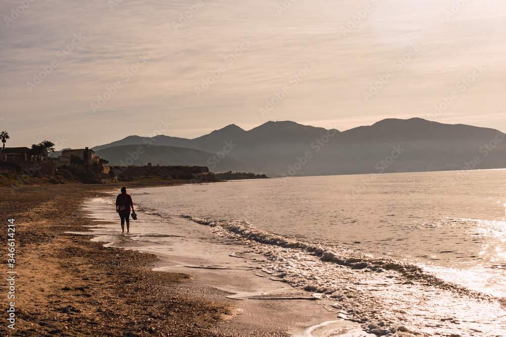 Woman walking on the beach Woman walking on the beach