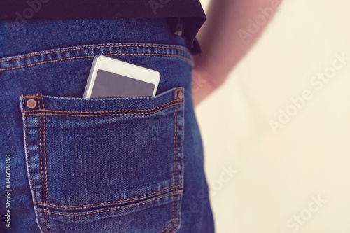 Phone and sunglasses in jeans pocket