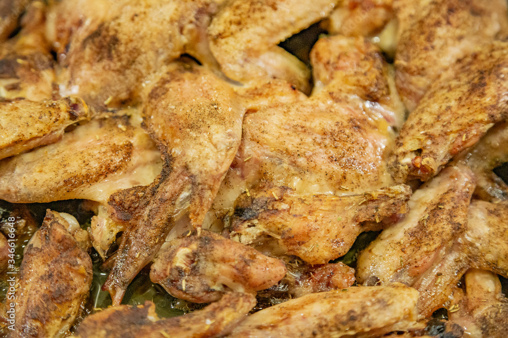 Fresh appetizing chicken wings fried on a kitchen gas stove Fresh appetizing chicken wings fried on a kitchen gas stove