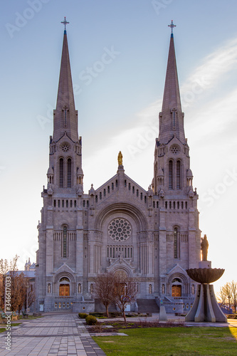 Vertical early morning view of the 1926 roman catholic Beaux-Arts style Basilica of Sainte-Anne-de-Beaupré along the St. Lawrence River, Quebec, Canada