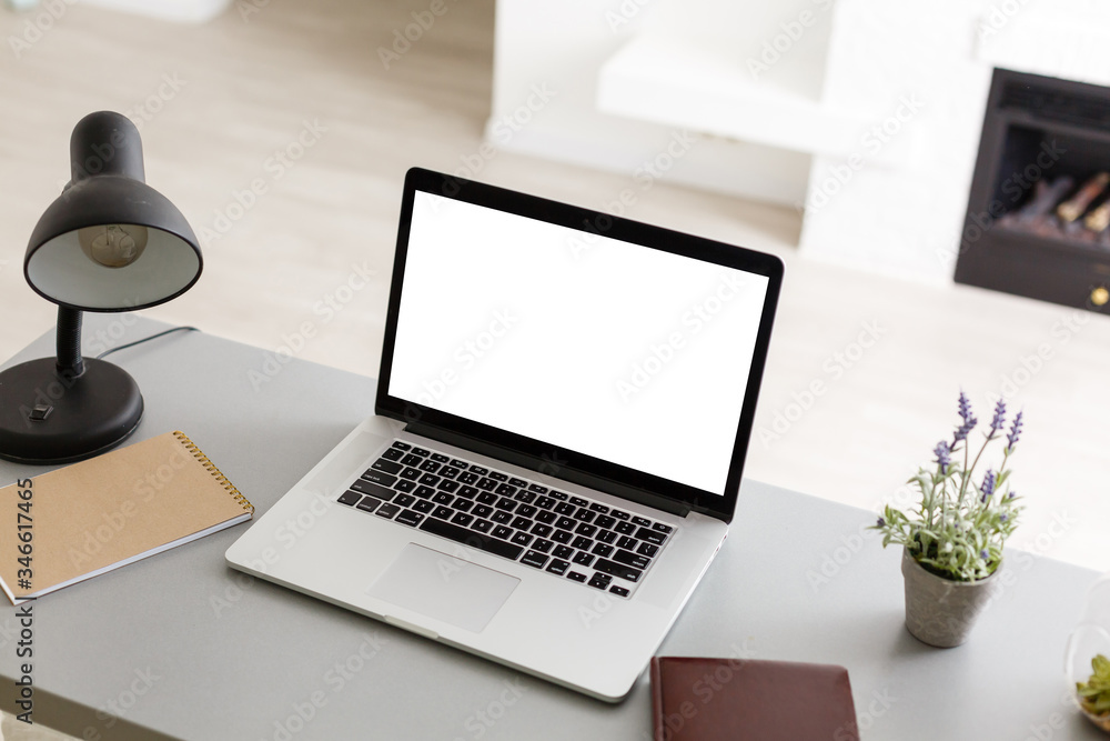 Laptop with blank screen on table