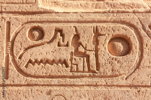 Ancient rock-cut hyroglyphs in southern Egypt in Abu Simbel. A close-up in the sunshine. The temple is located on a large reservoir. The word surround is called Cartouche.