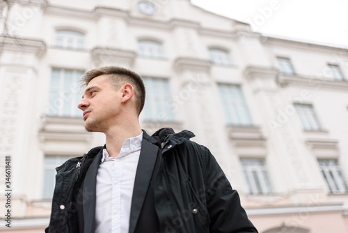 Wallpaper Mural Young man in jacket is standing outdoors Torontodigital.ca