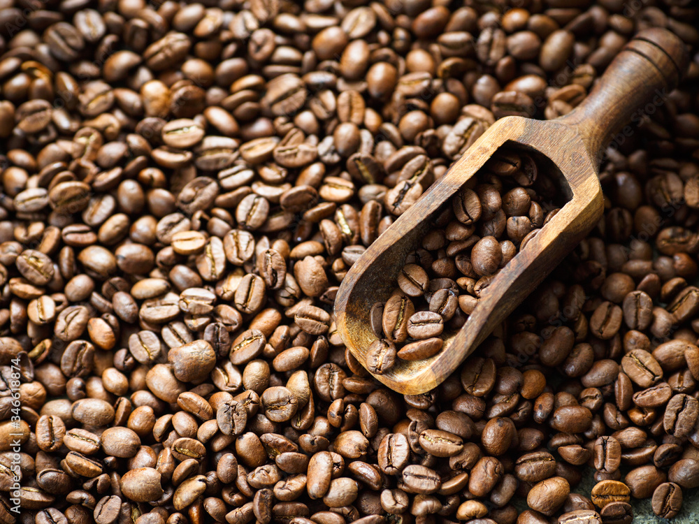 Fototapeta premium Lots of brown coffee beans, close-up. There is a place for the text.