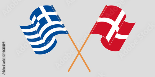 Crossed and waving flags of Greece and Denmark