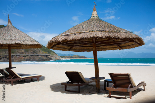 Sun beds with thatched roofs on the beach  Vinpearl  Nha Trang  Vietnam
