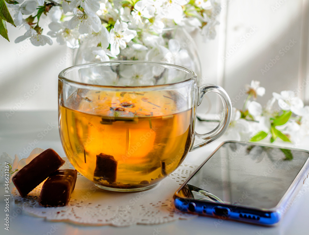 herbal tea and a telephone on the table herbal tea and a telephone on the table