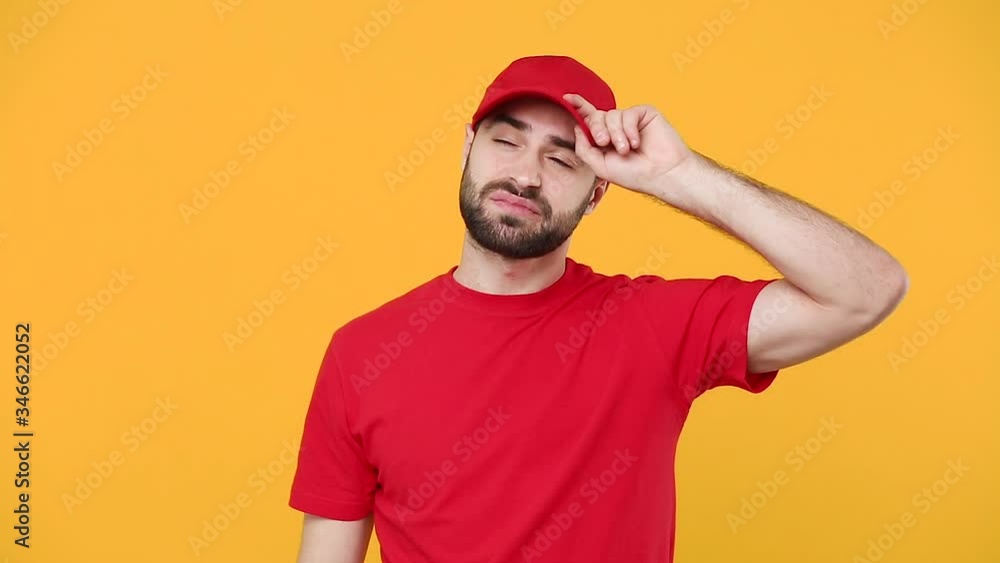 Delivery young guy man in red cap blank t-shirt uniform workwear isolated on yellow background studio Professional male deliveryman employee working as courier Service concept tired yawn want to sleep Delivery young guy man in red cap blank t-shirt uniform workwear isolated on yellow background studio Professional male deliveryman employee working as courier Service concept tired yawn want to sleep