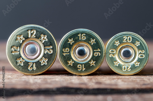 Selective targeting of 12,16 and 20-gauge shotgun cartridges used for hunting, on a wooden table