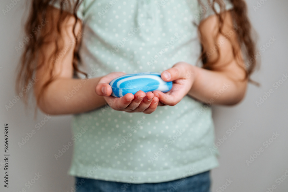 A girl holding soap in her hands. A girl holding soap in her hands.