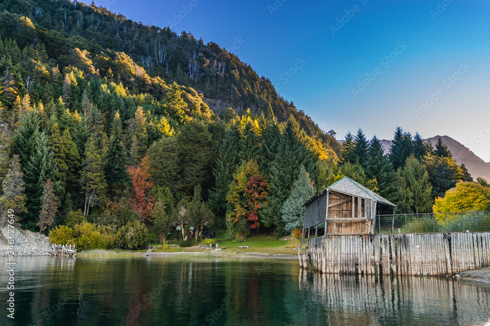 small cabin on a beautiful lake in autumn