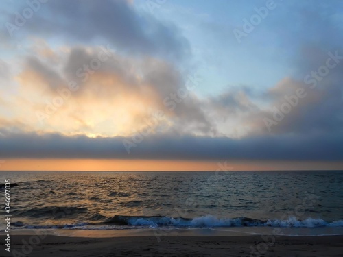 Spring cloudy sunrise on Black sea, public beach in Odesa, Ukraine