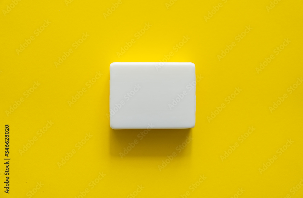 White soap on a yellow background. Hand hygiene. Washing hands is a best way to prevent coronavirus Covid-19 while global pandemic. White soap on a yellow background. Hand hygiene. Washing hands is a best way to prevent coronavirus Covid-19 while global pandemic.