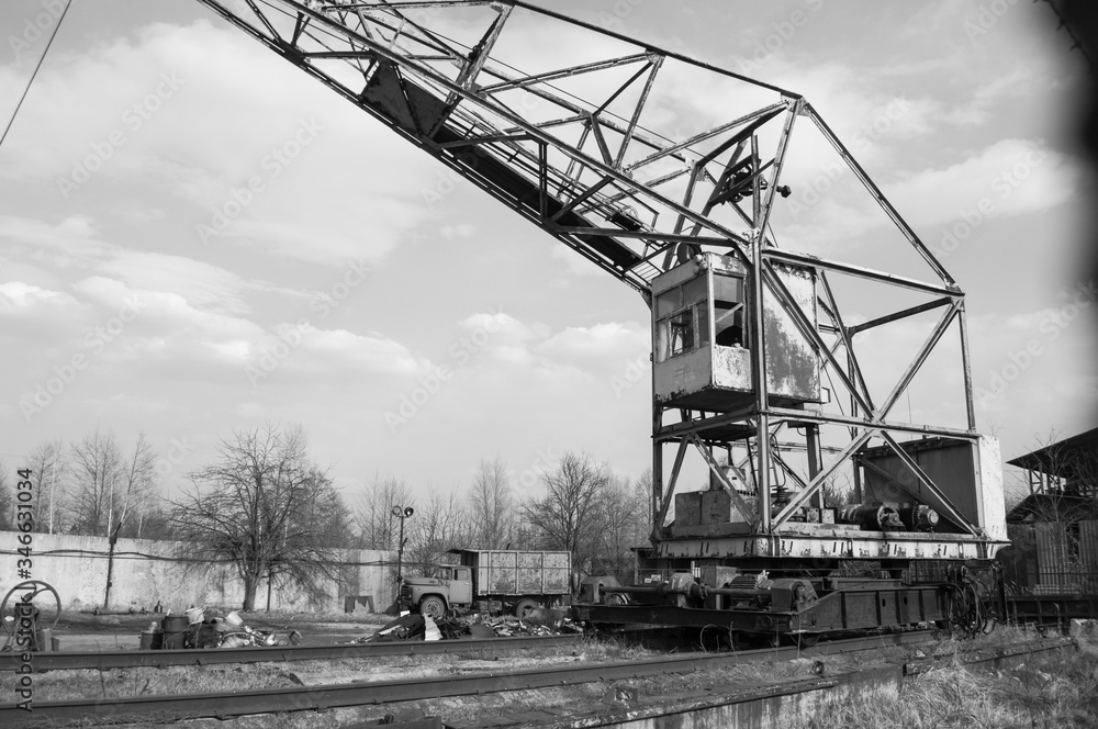 rusty crane on sky background, black and white photo rusty crane on sky background, black and white photo