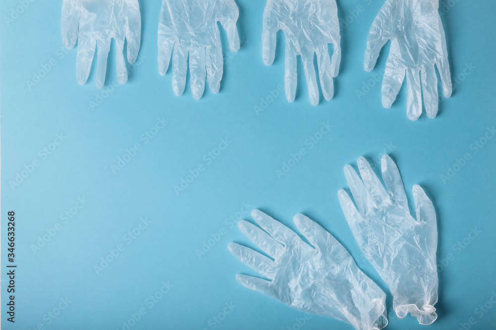 Whitte surgical gloves isolated on the blue background. Concept protect against infection or contamination