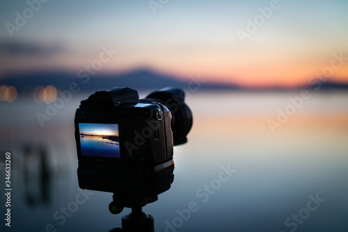 Landscape photoshoot camera on tripod at sunset