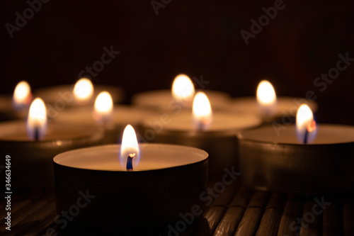Close up of candles in the dark with copy space.