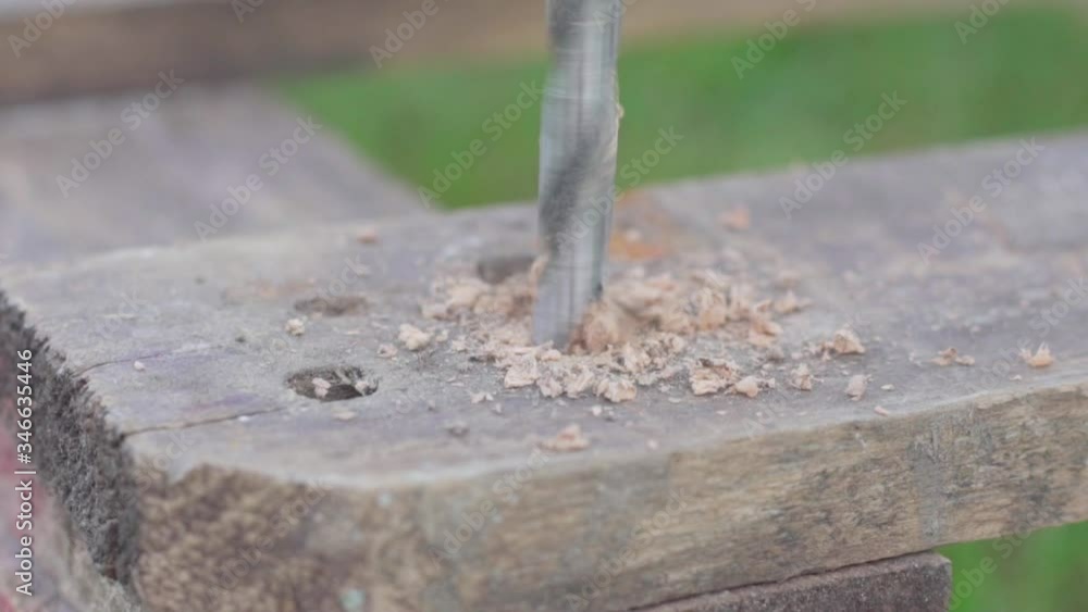 carpenter using drill machine on wood.Man drills a tree with a drill. Repair in the apartment. Wood workshop. carpenter using drill machine on wood.Man drills a tree with a drill. Repair in the apartment. Wood workshop.