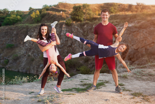 Obraz na plátne Happy young family having fun outside in summer nature