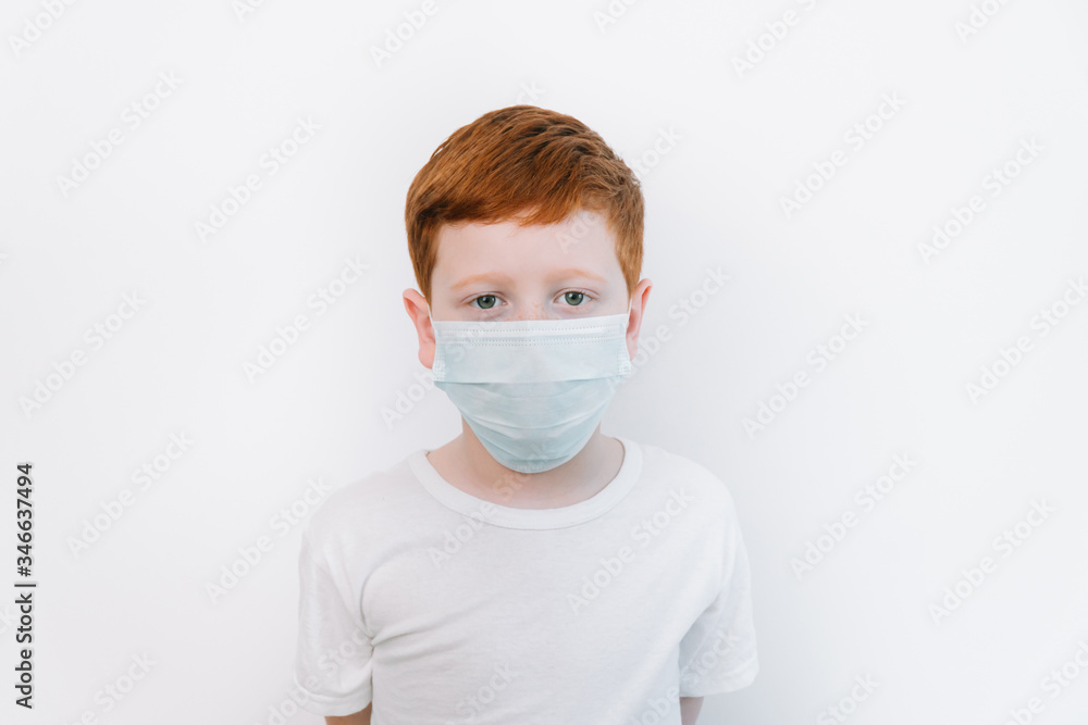 Close up of caucasian little boy in blue protective mask. Flu protection Close up of caucasian little boy in blue protective mask. Flu protection