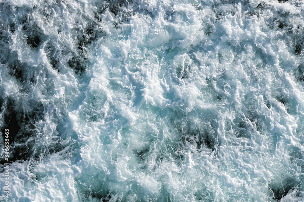 Ocean water abstract background. Sea bubbling water texture closeup