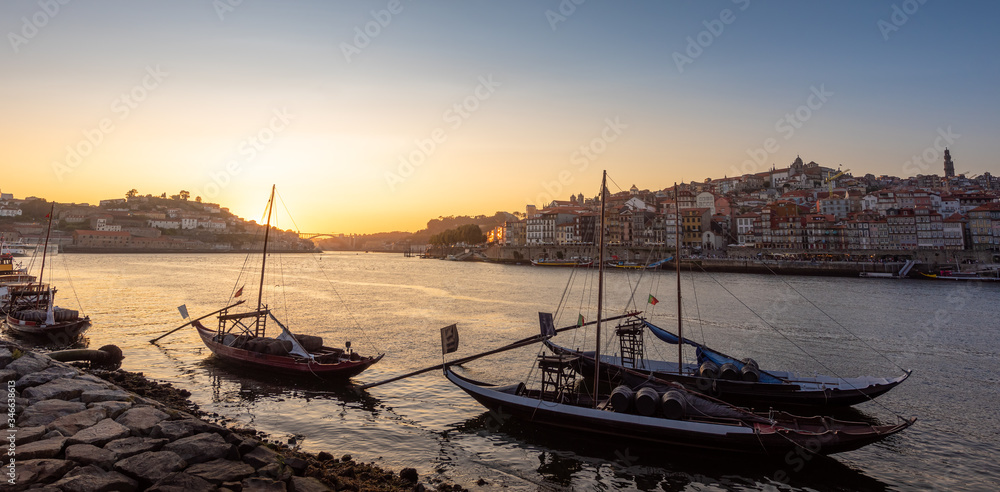 Panoramic of Porto cityscape in sunset with river on the front and wine carrier ship in  foreground and city of Porto in background, Portugal