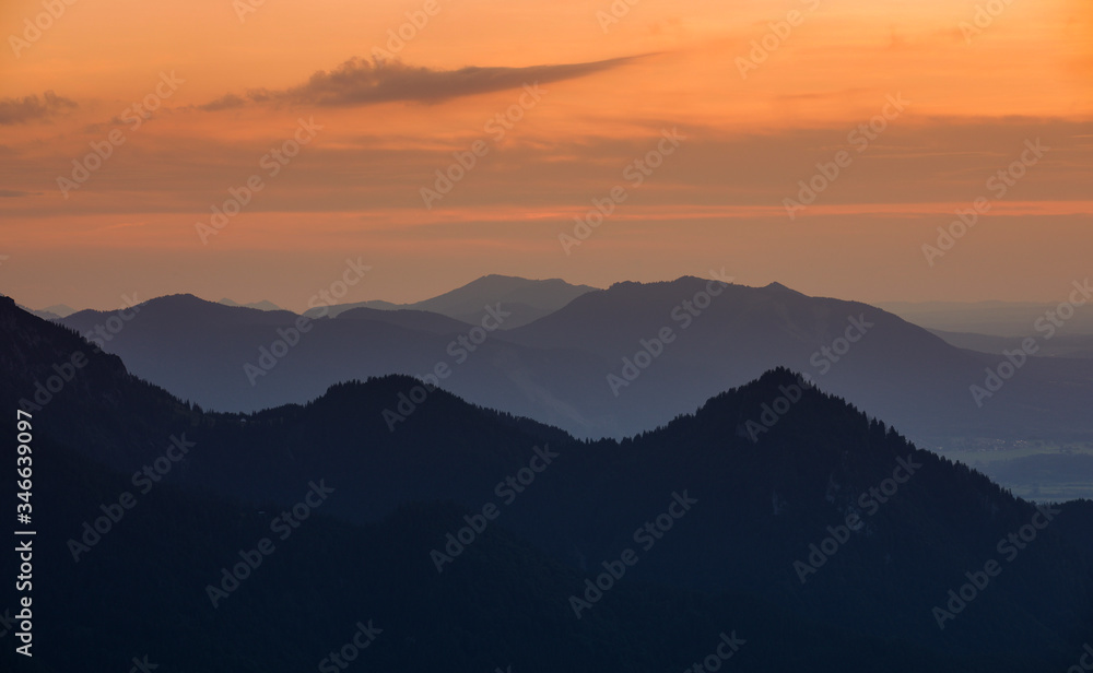 Mountain silhouettes of the Bavarian Alps during sunset from Jochberg Walchensee, Bavaria Germany.
