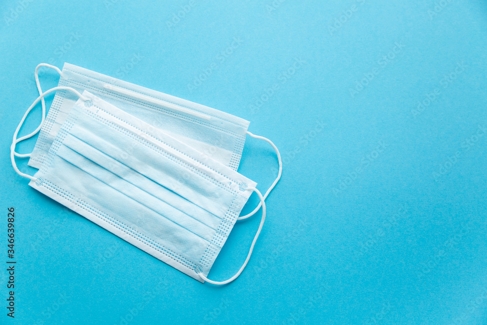 White and blue mask on a blue background on the left.the view from the top White and blue mask on a blue background on the left.the view from the top