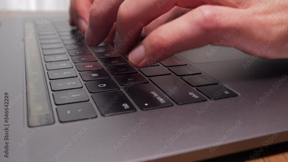 Close-up of fingers typing on the keyboard of a laptop Close-up of fingers typing on the keyboard of a laptop