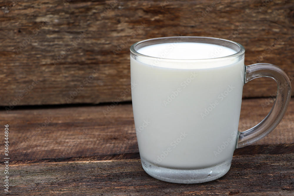 A glass of milk on wooden background. Fresh milk. A cup of milk. Healthy food A glass of milk on wooden background. Fresh milk. A cup of milk. Healthy food