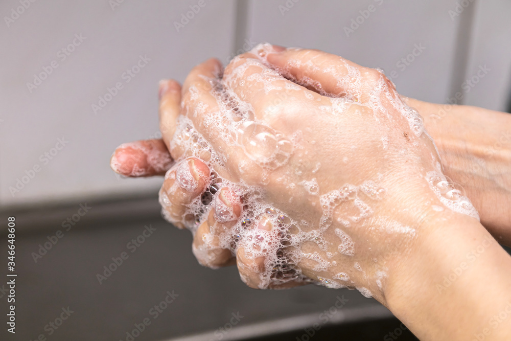Woman use soap and washing hands under the water tap. Hygiene concept hand detail. Woman use soap and washing hands under the water tap. Hygiene concept hand detail.
