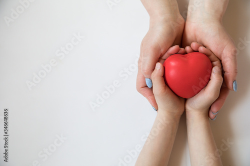 Fototapeta Naklejka Na Ścianę i Meble -  Heart in hands on light background. Healthcare background.