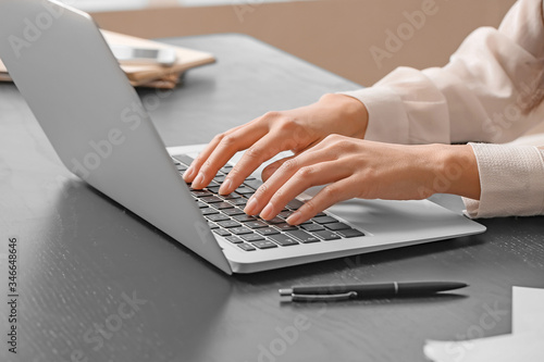 Tableau sur toile Beautiful secretary working on laptop in office, closeup