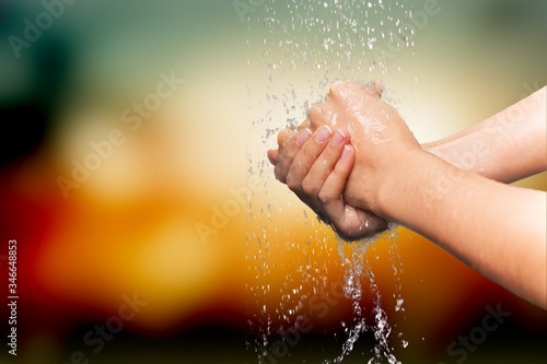 Human washing hands in clean water