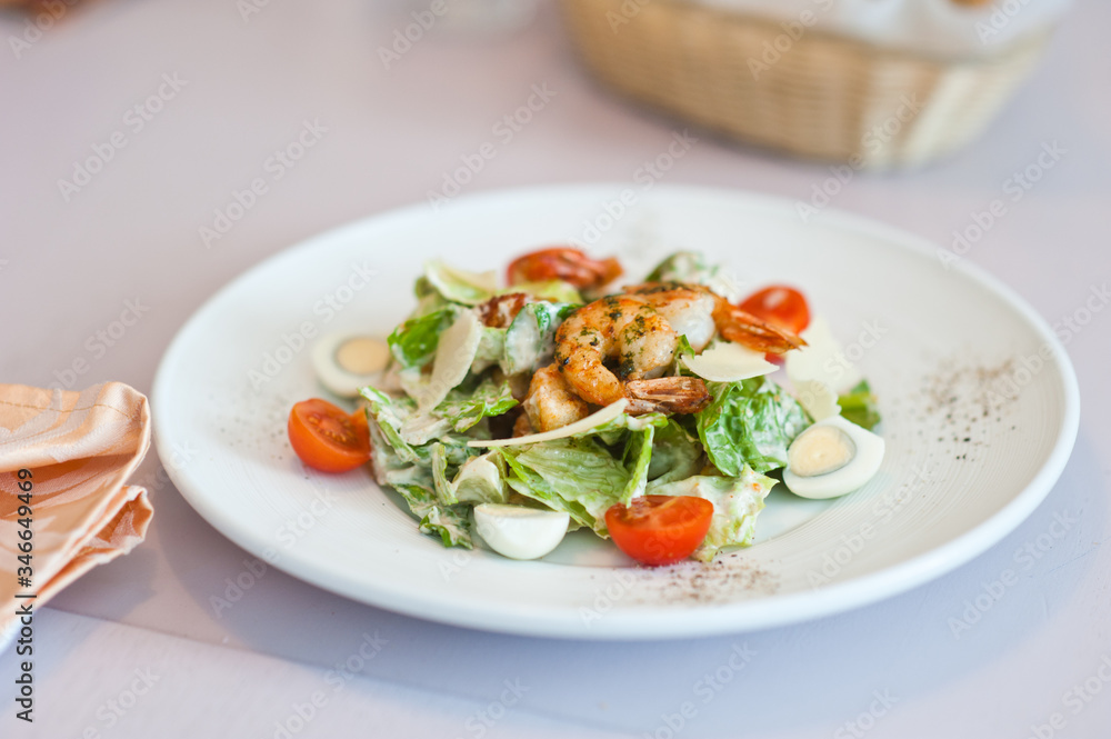 Shrimp salad in a white plate on a table at cafe. Shallow depth of field. Shrimp salad in a white plate on a table at cafe. Shallow depth of field.